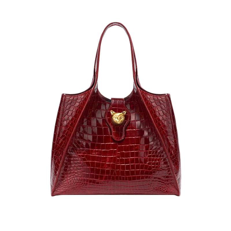 Red crocodile-patterned handbag with a gold emblem on a light gray background, featuring the brand 'Bafelli'.