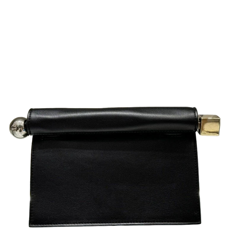 Black paper towel holder with a white box on a gray surface