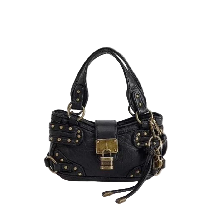 Black handbag with gold accents on a light gray background