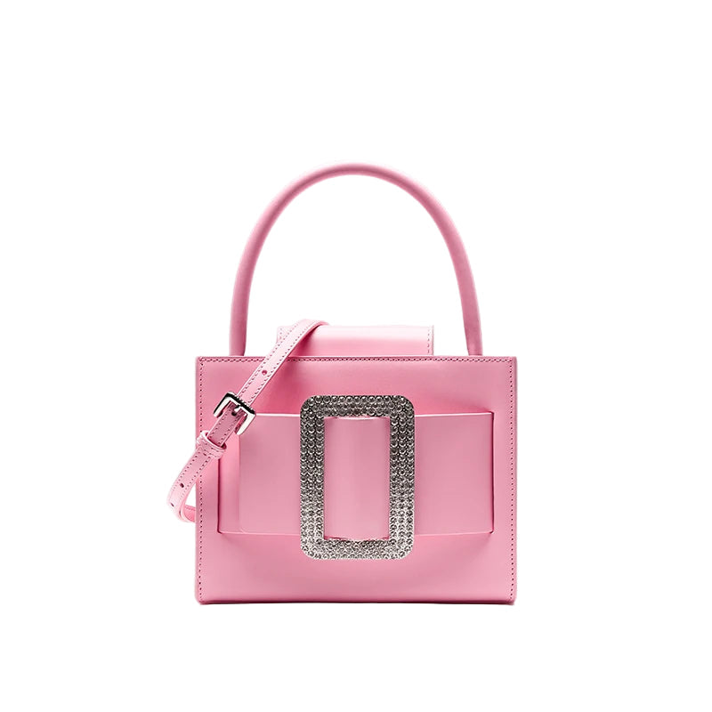 Pink handbag with a decorative silver buckle on a light gray background, featuring the brand 'Bafelli'.