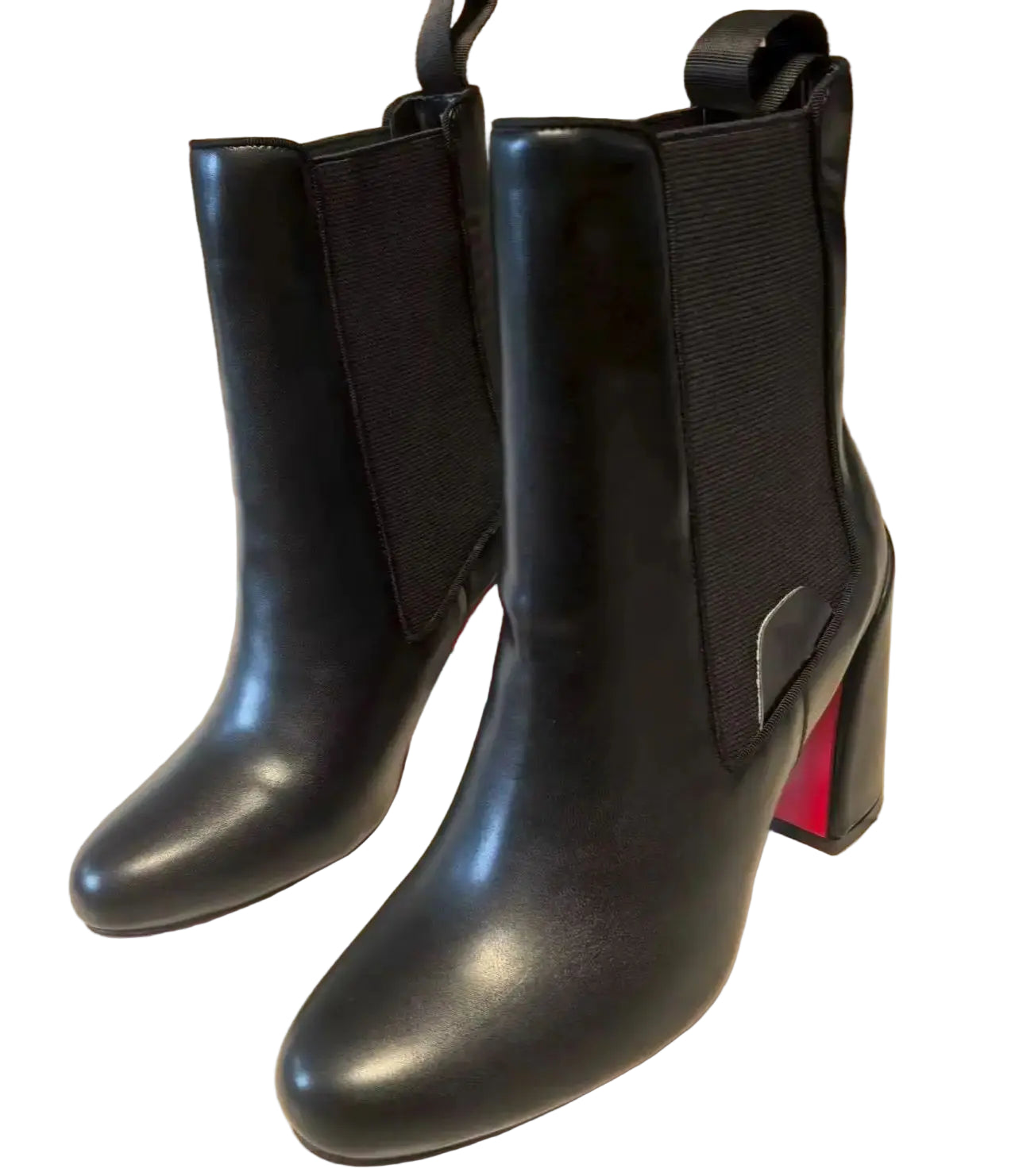 Black ankle boots with elastic sides on a light-colored floor.