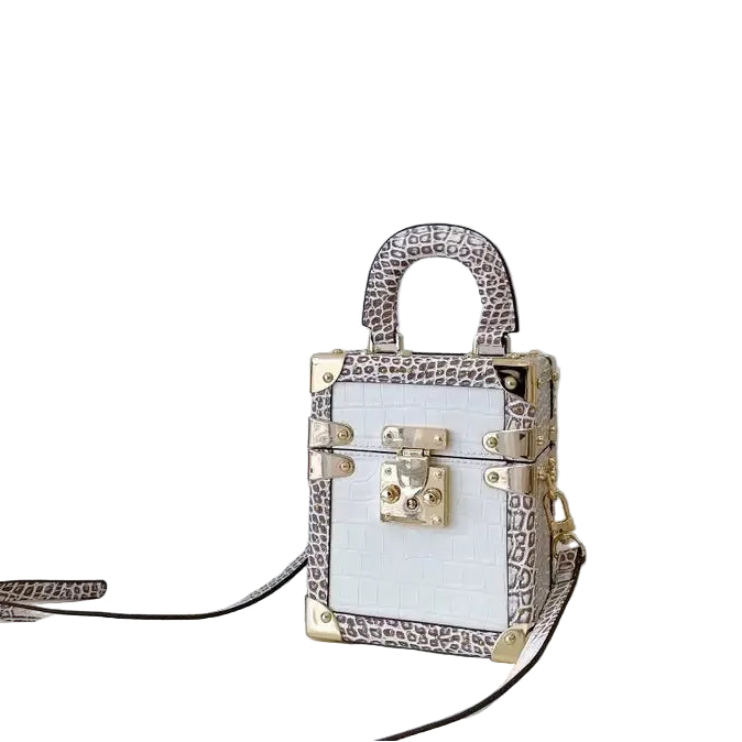 Small handbag with intricate design on a white surface and light gray background