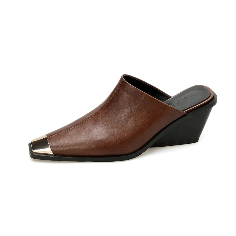 Brown leather wedge shoe with a black sole on a white background