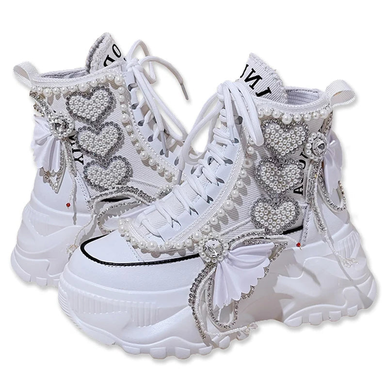 White sneakers with decorative elements on a white background