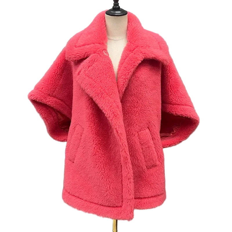 Red fluffy coat on a mannequin against a gray background