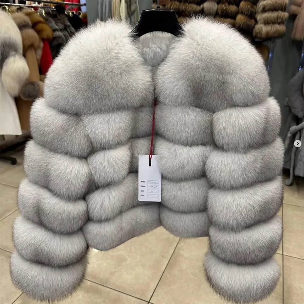 Gray fur vest on a mannequin with a tag in a store setting