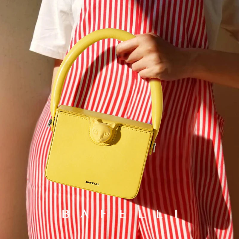 Person holding a yellow handbag with a red and white striped dress, brand 'Bafelli' visible.