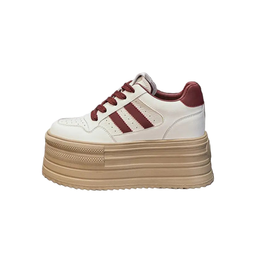 White sneaker with red accents on a dark surface